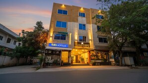 A multi-story hotel with a modern facade, illuminated signage, and a well-maintained entrance area. - Fabhotel Csfc (Bhopal)