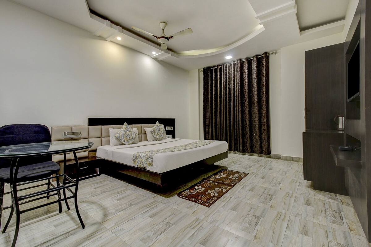A modern bedroom with a bed, a desk, and a chair.