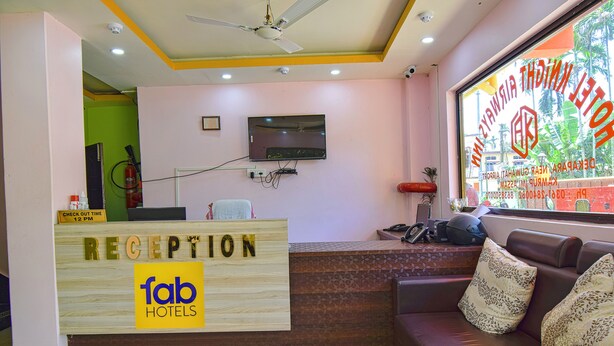 A reception area with a wooden desk labeled "RECEPTION" and "fab hotels". - Fabhotel Knight Airways (Guwahati)