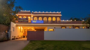 A hotel with a traditional architectural style, featuring arched windows and a central entrance. - FabHotel JBS Heritage (Jaipur)