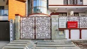 A gated entrance with a sign for Dr. Divya Sharma (PT) Sports Physiotherapist, number 11 on Market Road. - Fabexpress Primero I (Gurugram)