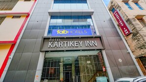 A modern building with a sign for 'fab hotels' and 'KARTIKEY INN'. - Fabexpress Kartikey Inn (Haridwar)
