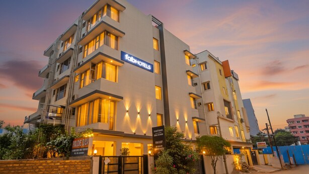A multi-story hotel with a modern facade, balconies, and illuminated windows. - Fabhotel Pride Inn (Hyderabad)