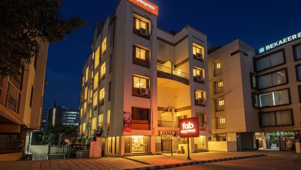 A multi-story hotel with a prominent 'Jana Express' sign at the ground level. - FabHotel East Field Homes (Pune)