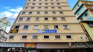 A multi-story hotel with a sign for 'FabHotels'. - FabHotel Peninsula (Mumbai)