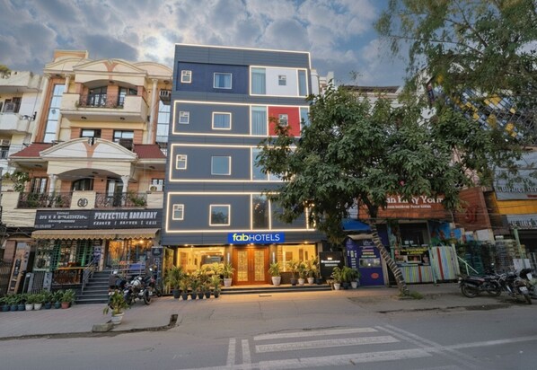 A multi-story hotel with a modern facade, a visible entrance, and a signboard for 'fabHOTELS'.