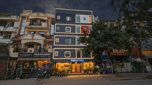 A multi-story hotel with a modern facade, featuring a prominent 'fabHOTELS' sign.