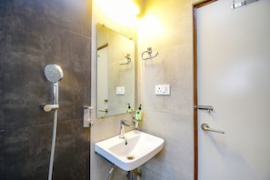A bathroom with a shower, sink, and mirror. - Fabhotel Stay Inn International (Kolkata)