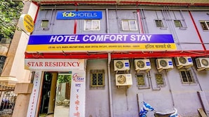 A building with a sign for 'Fab Hotels' and 'Hotel Comfort Stay'. There is a sign for 'Star Residency' and multiple air conditioning units attached to the building. - FabHotel Comfort stay (Mumbai)