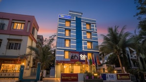 A multi-story building with a sign for 'Fab Hotels'. - Fabhotel Happy Homely Stay (Pune)