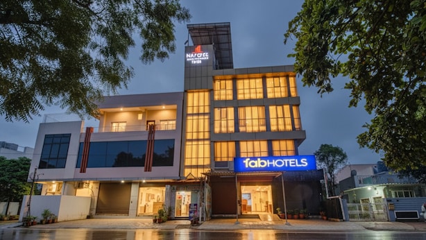A modern hotel with a prominent 'fabHOTELS' sign, featuring a two-story structure with large windows and a flat roof. - FabHotel Saket Inn (Bhopal)