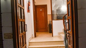 A staircase leading to a door marked with the number 102. - FabHotel Premium- 10min Walk from Millennium City Centre Gurugram Gurgaon (Gurugram)