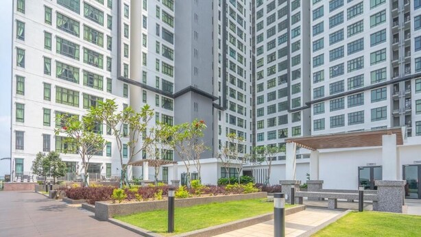 A modern residential building with multiple floors, a courtyard with greenery, and a covered seating area. - D'Summit Residences by YML Home B1 (Johor Bahru)