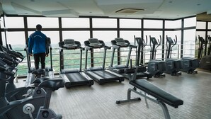 A gym with treadmills, ellipticals, and a bench. - D'Summit Residences by YML Home B1 (Johor Bahru)