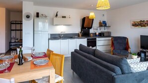 Een modern appartement met een eetgedeelte, keuken en woonkamer.