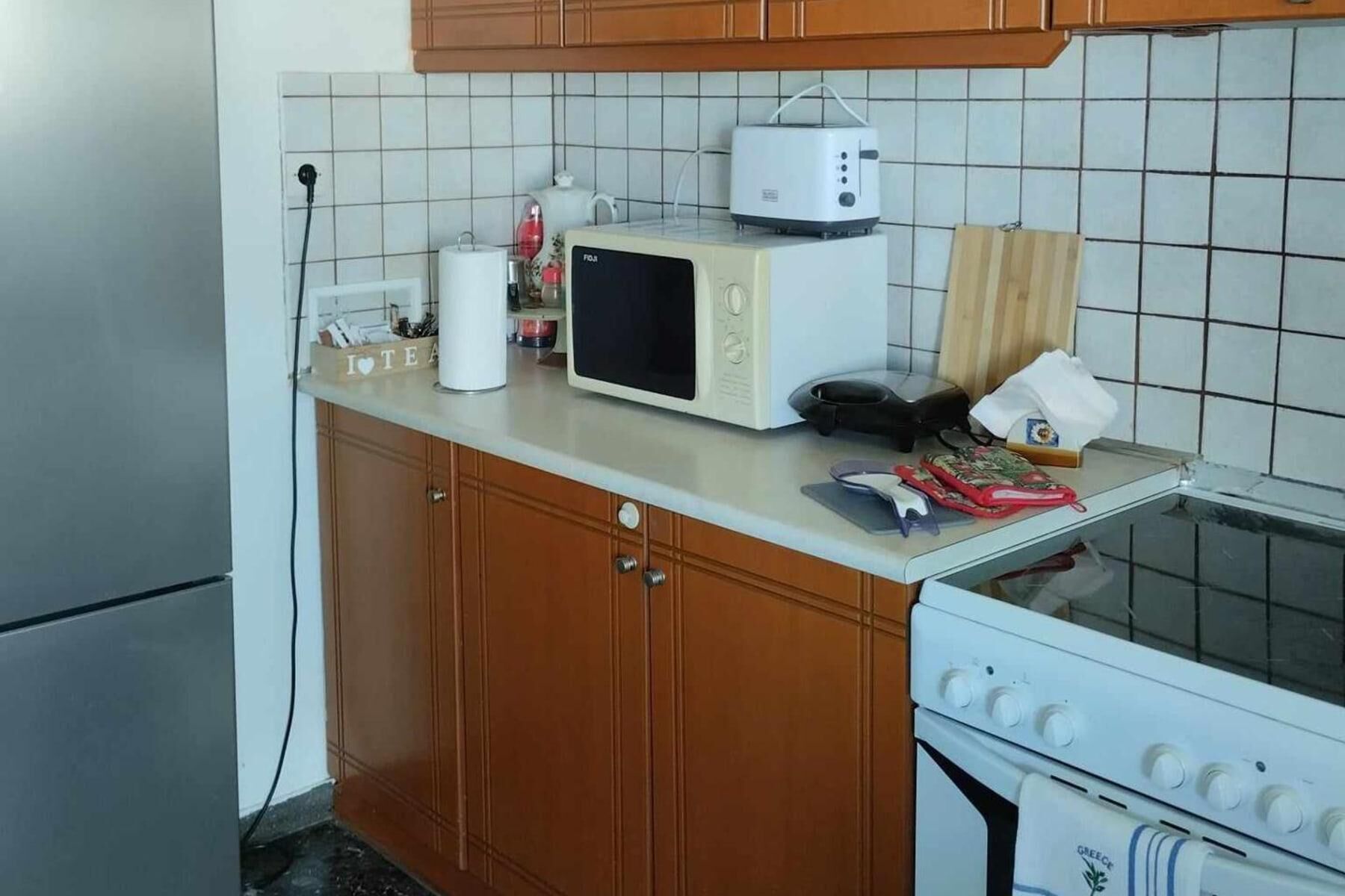 A kitchen with a microwave, toaster, and a stove.