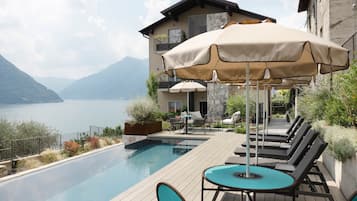 Seasonal outdoor pool, open 9:00 AM to 6:00 PM, pool umbrellas