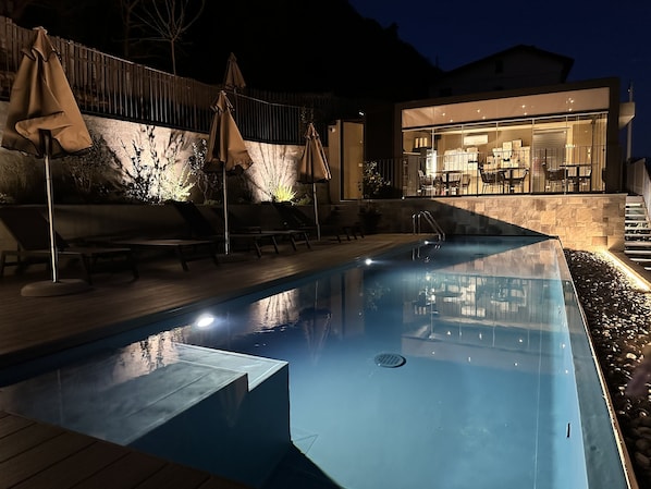 Seasonal outdoor pool, open 9:00 AM to 6:00 PM, pool umbrellas