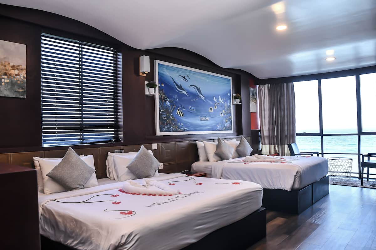 Deluxe Triple Room, Beach View | In-room safe, desk, laptop workspace, soundproofing