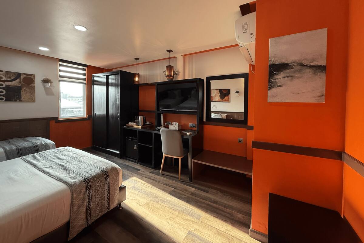 Deluxe Triple Room, City View | In-room safe, desk, laptop workspace, soundproofing