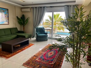 Sea View Family Suite | Living area | 30-inch flat-screen TV with digital channels, TV