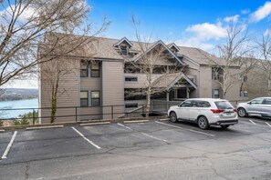 A multi-story building with a parking lot in front. - Modern Luxury Condo with Private Deck, Amazing Views, Near SDC with Free Tickets (Branson)