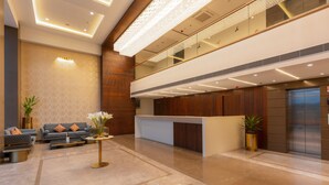 A modern hotel lobby with a reception desk, seating area, and a large chandelier. - Effotel By Sayaji Bhopal (Bhopal)