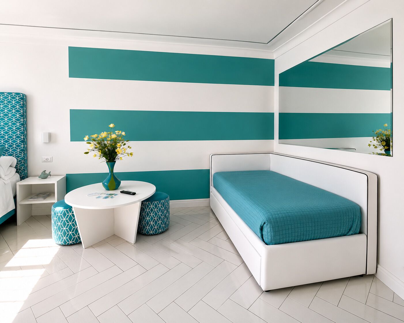 A modern bedroom with a bed, a bedside table, a round table, and a mirror.
