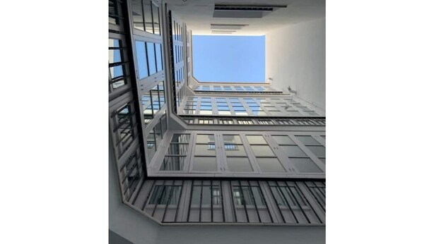 A modern building with multiple levels and large windows. - 2 Flamenco 2A (Cádiz)