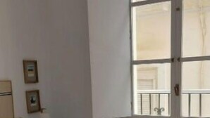 A hotel room with two beds, a large window, and a door. - 2 Flamenco 2A (Cádiz)