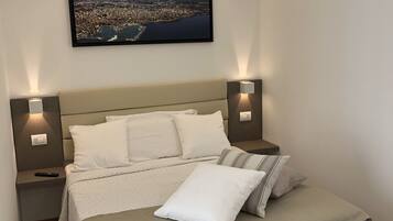 Deluxe Quadruple Room | Minibar, in-room safe, desk, laptop workspace