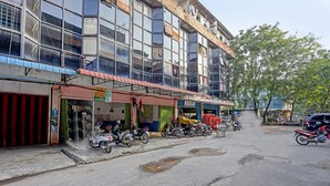 A multi-story building with a row of shops on the ground floor. - Hotel O Suci Homestay SyariahNearKilas 7 TV (Batam)