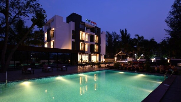 A modern hotel with a pool area at dusk. - Apricsu Treeo Lonavala (Mawal)