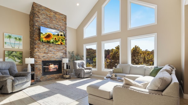 A spacious living room with a fireplace, large windows, and a comfortable seating area.