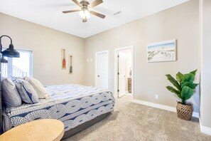 A bedroom with a bed, a ceiling fan, a window, a door, and a plant. - Luxury Home on Cove with Boat Slip, Waterslides, and Jump Deck (Linn Creek)