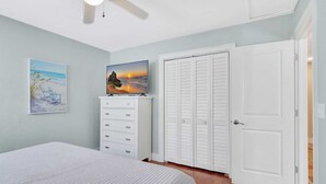 A bedroom with a bed, a dresser, a television, and a set of lockers. - A Private Oasis Complex in Naples (Naples)