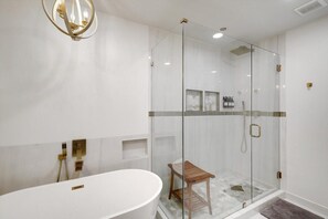 Bathtub, hair dryer, towels, shampoo