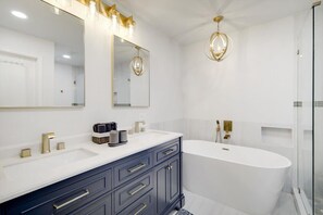 Bathtub, hair dryer, towels, shampoo