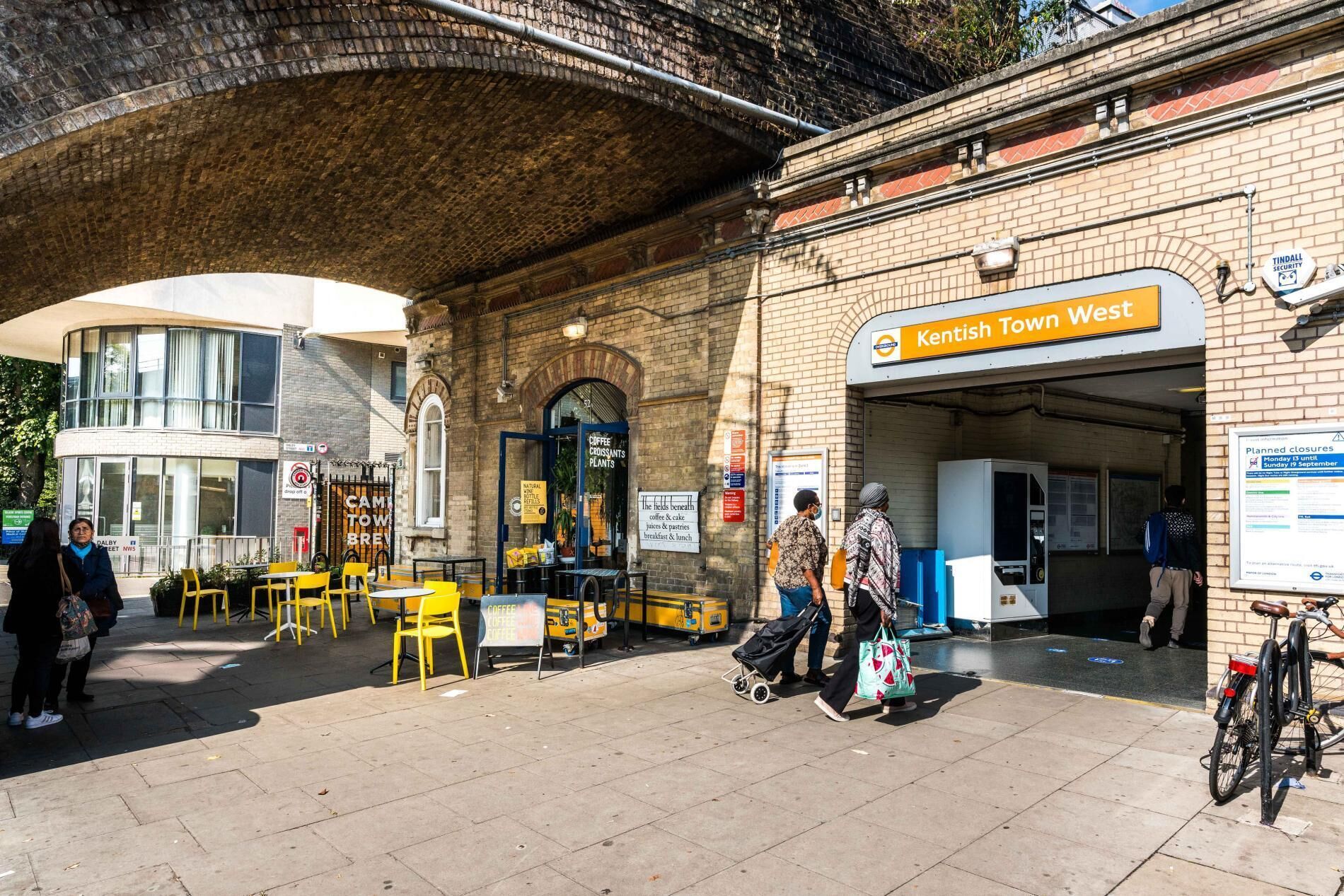 A public transport station with a sign for 'Kentish Town West'.