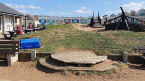 A beachside area with wooden benches and a wooden platform. - Large 3 bed bungalow set in Woodland grounds near Tamar lakes and local beaches (Kilkhampton)