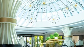 A spacious lobby with a high ceiling and a large glass dome. - Calido Maris Hotel (Manavgat)
