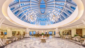 A spacious lobby with a central atrium, marble flooring, and modern seating areas. - Calido Maris Hotel (Manavgat)