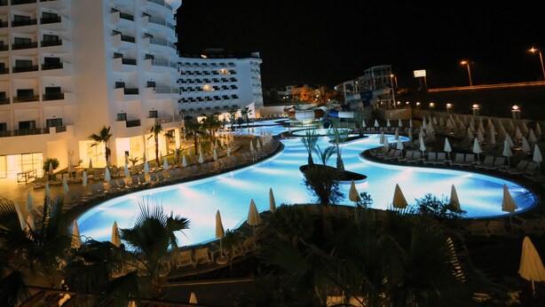 A hotel with a pool area featuring multiple water features and lounge chairs. - Calido Maris Hotel (Manavgat)
