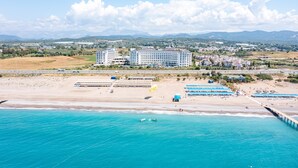 A coastal hotel with a beach view, a pier, and a mountainous backdrop. - Calido Maris Hotel (Manavgat)