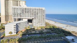 A high-rise hotel with multiple balconies overlooking a beach. - 1201 South Hampton 2 Bedroom Condo (Myrtle Beach)
