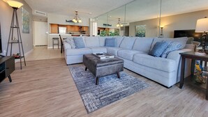 A modern living room with a sectional sofa, a coffee table, and a rug. - 1201 South Hampton 2 Bedroom Condo (Myrtle Beach)