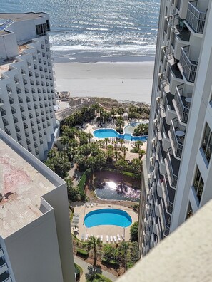 A high-rise hotel overlooking a beach with multiple swimming pools and a view of the ocean. - 2307 Royale Palms 3 Bedroom Condo (Myrtle Beach)