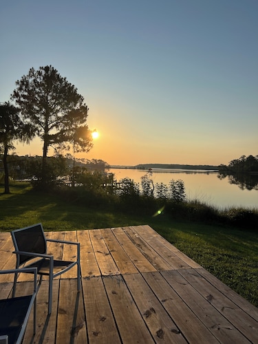 Enjoy this waterfront home with a pool, dock, and Blue Angels! Bring your boat! 
