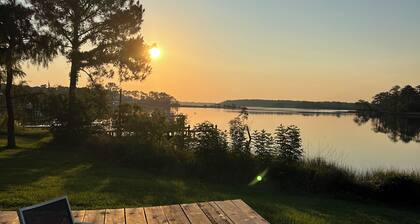 Enjoy this waterfront home with a pool, dock, and Blue Angels! Bring your boat!