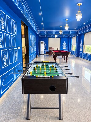 A room with a foosball table, a pool table, and a billiards table. - Trulyy The Shakti Vilas (Udaipur)
